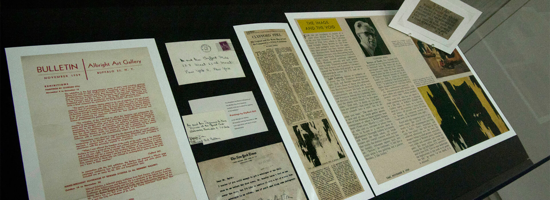 Photo of clippings in a display case in 1959 exhibition