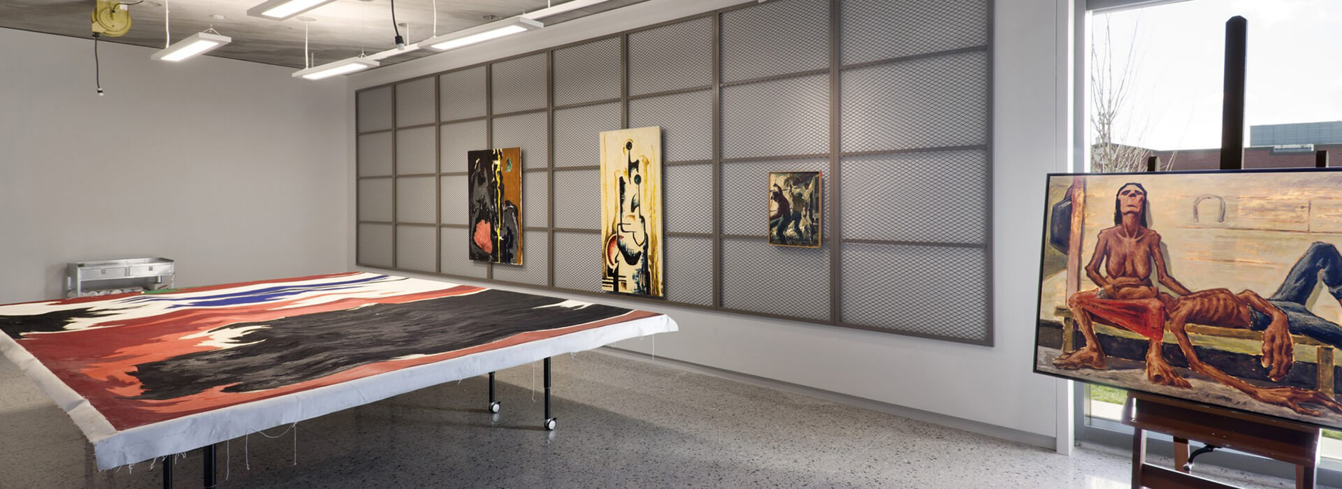 Art conservation studio at the Clyfford Still Museum with paintings on tables and the wall