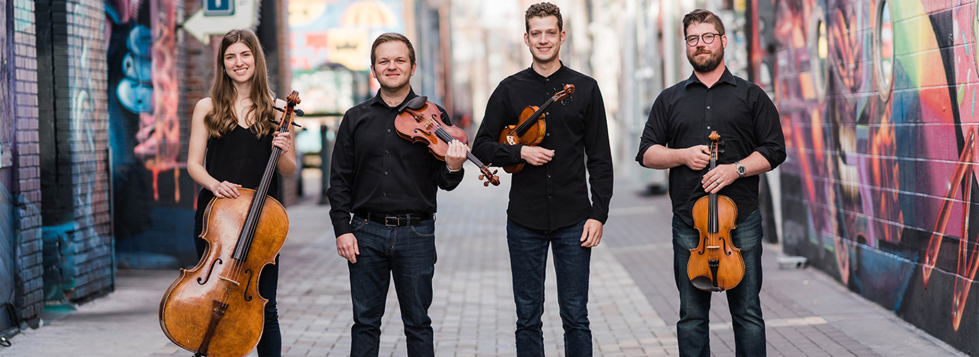 String quartet stands in a city scene