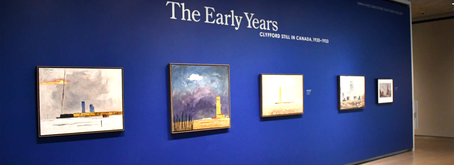 Photo of a blue wall with art and the words The Early Years