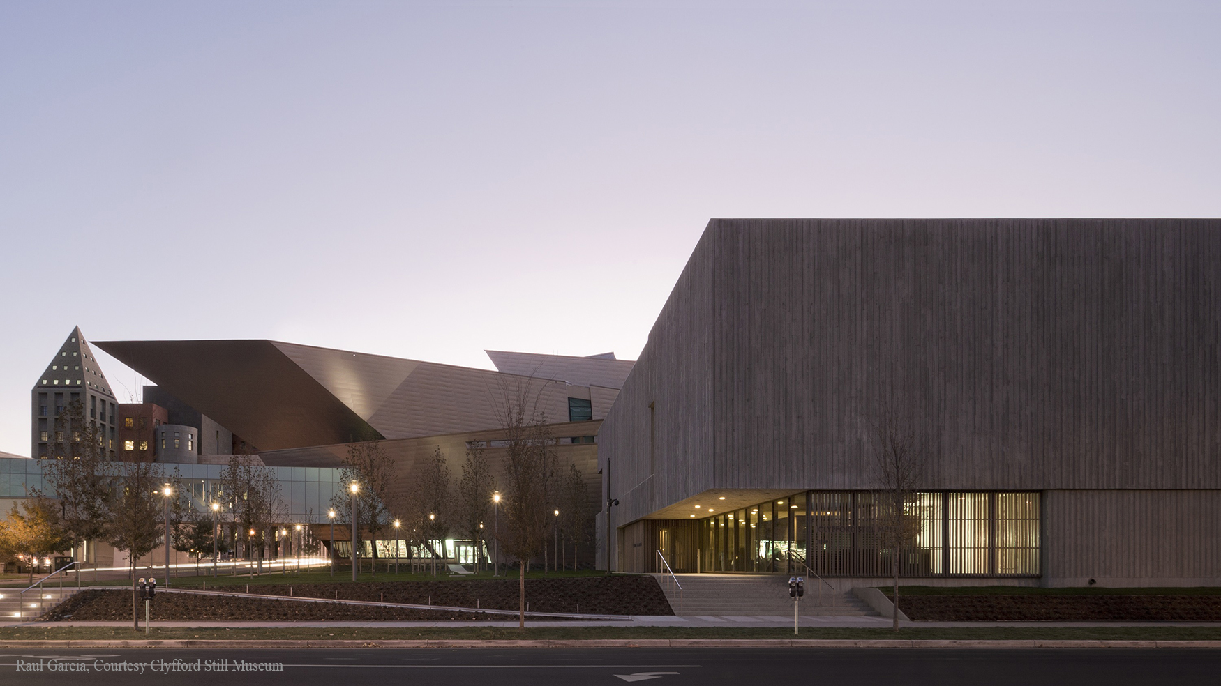 Exterior of the Clyfford Still Museum from the west end at dawn with the Denver Art Museum's Hamilton Building visible in the background