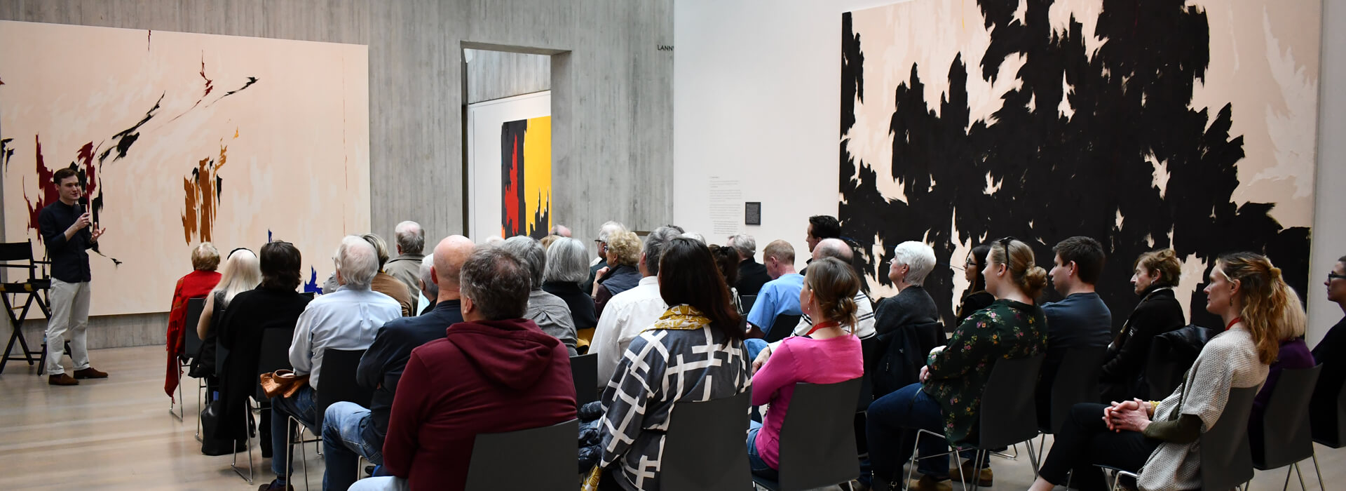 Guests listen to speaker at One Painting at a Time lecture