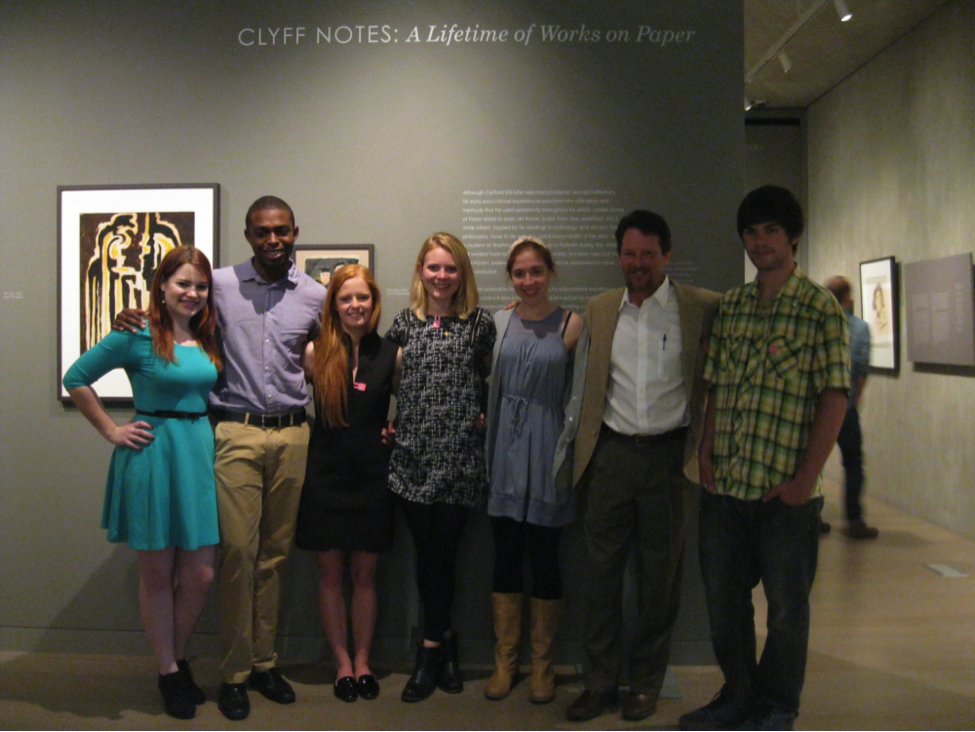 A group of college students stands in front of art at the Clyfford Still Museum