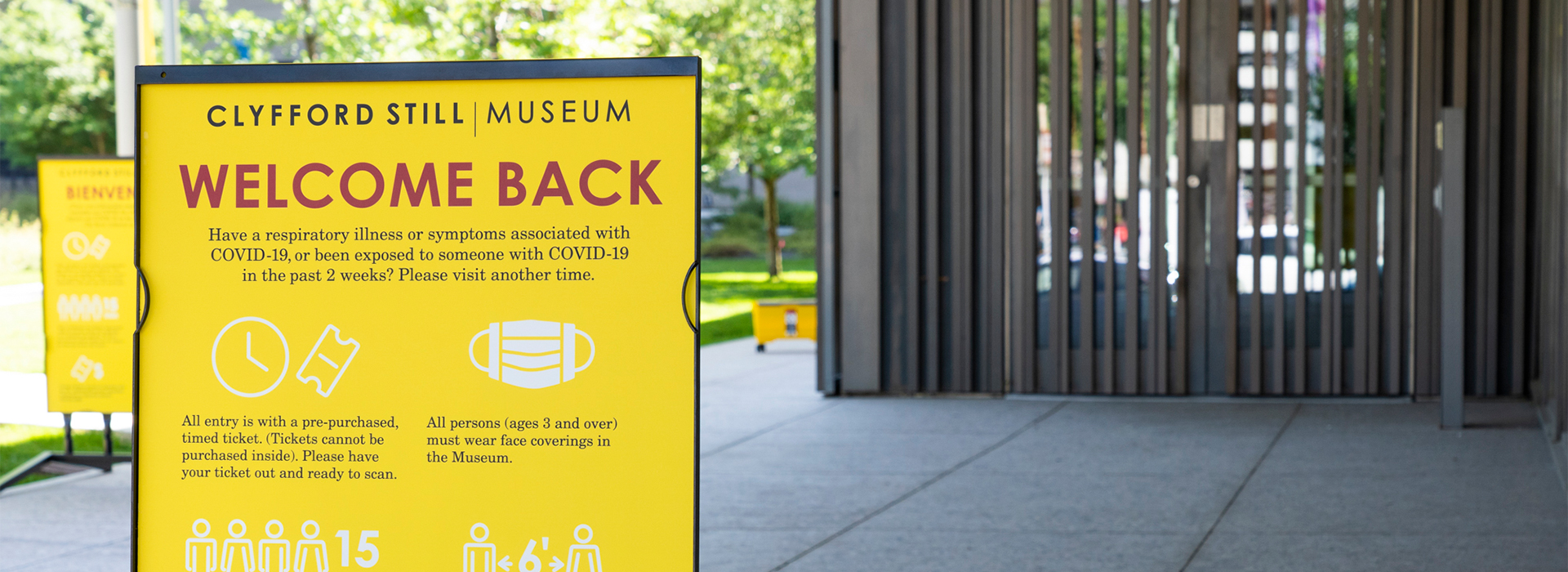 Closeup of a welcome back sign in front of the entrance to the Clyfford Still Museum