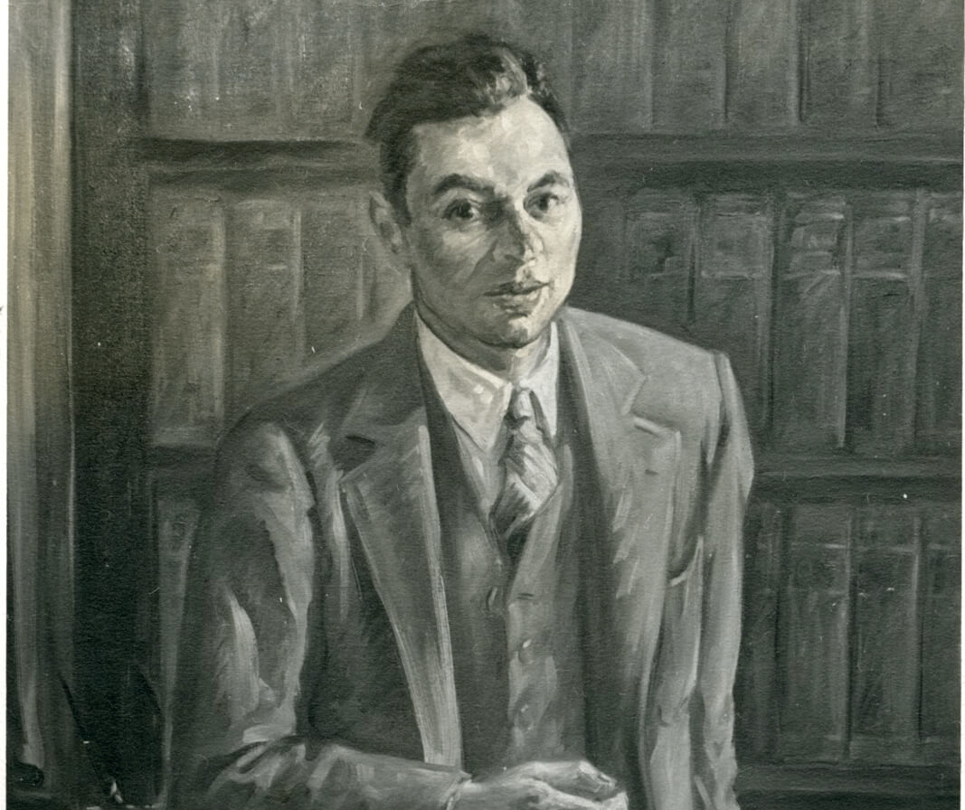 Portrait of a man in a suit holding a cigarette