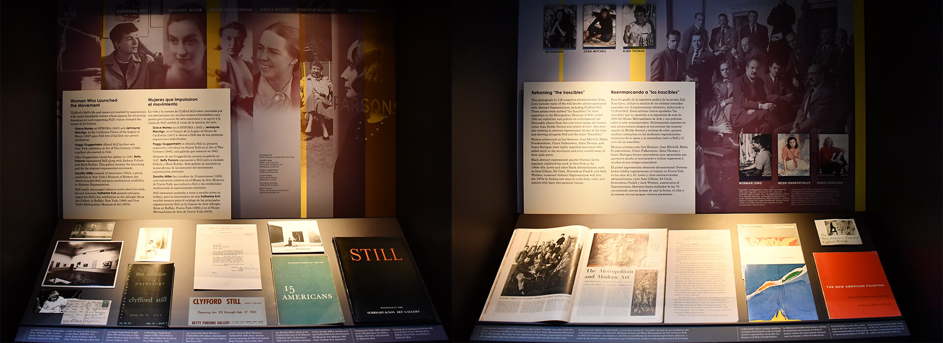 Two display cases include photographs and archival materials