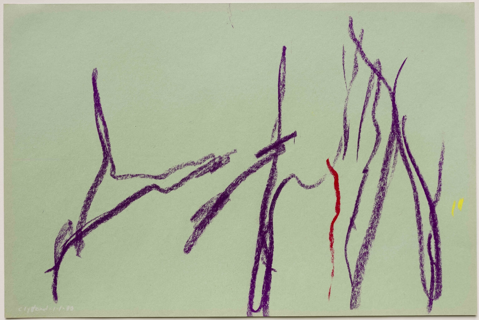 Purple and red lines and marks on a piece of light pastel green construction paper