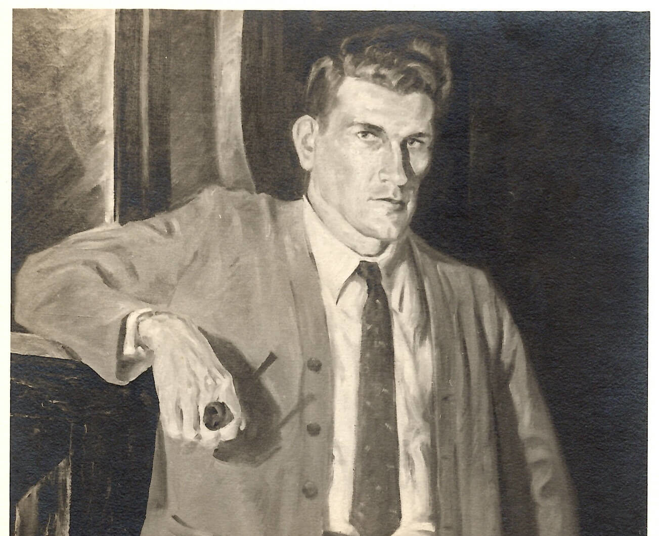 Portrait of a man wearing a jacket and tie standing with one arm leaning on something behind him