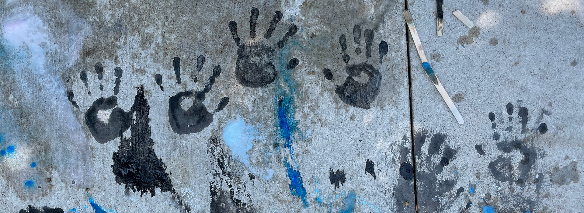 Hand prints in ice chalk on the sidewalk