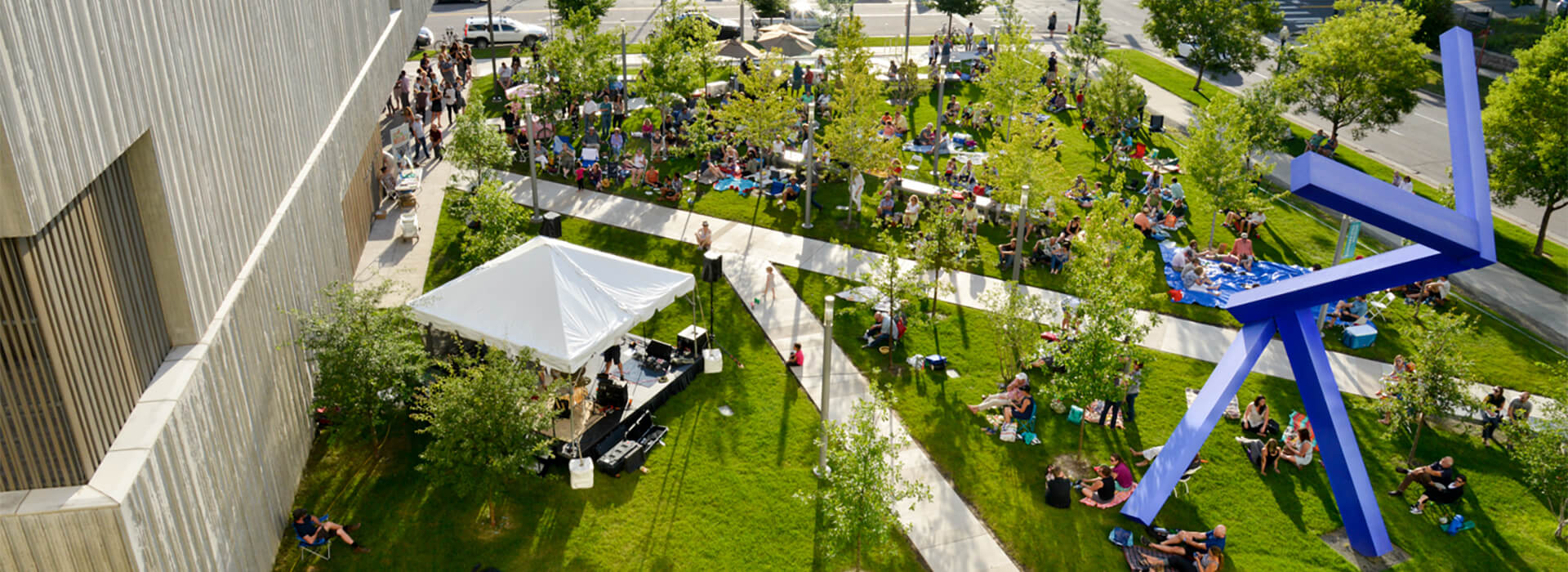 Looking down at the Clyfford Still Museum forecourt at a crowd attending a free lawn concert