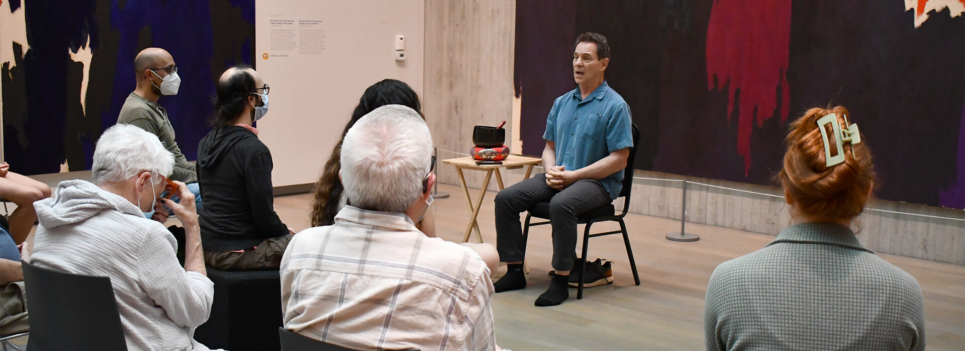 People meditating in an art museum