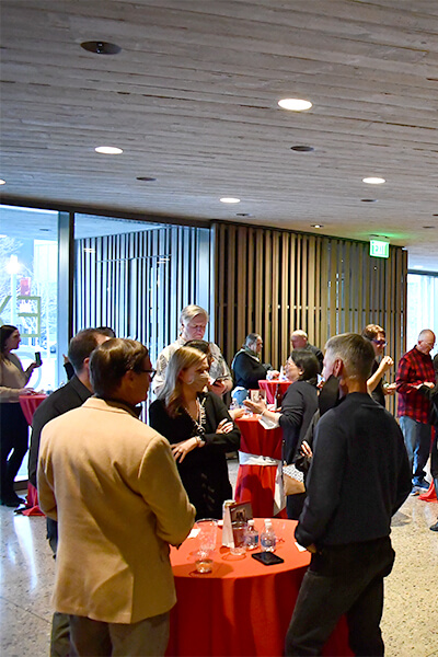 People attend a reception in the lobby of the Clyfford Still Museum