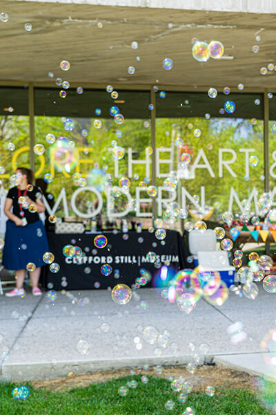 Outside the front of the Clyfford Still Museum with a bubble machine