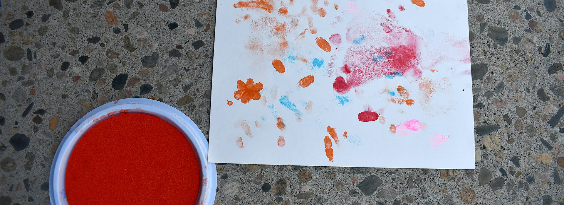 Baby hand and footprints in paint on paper