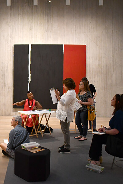 Teachers talk in a gallery