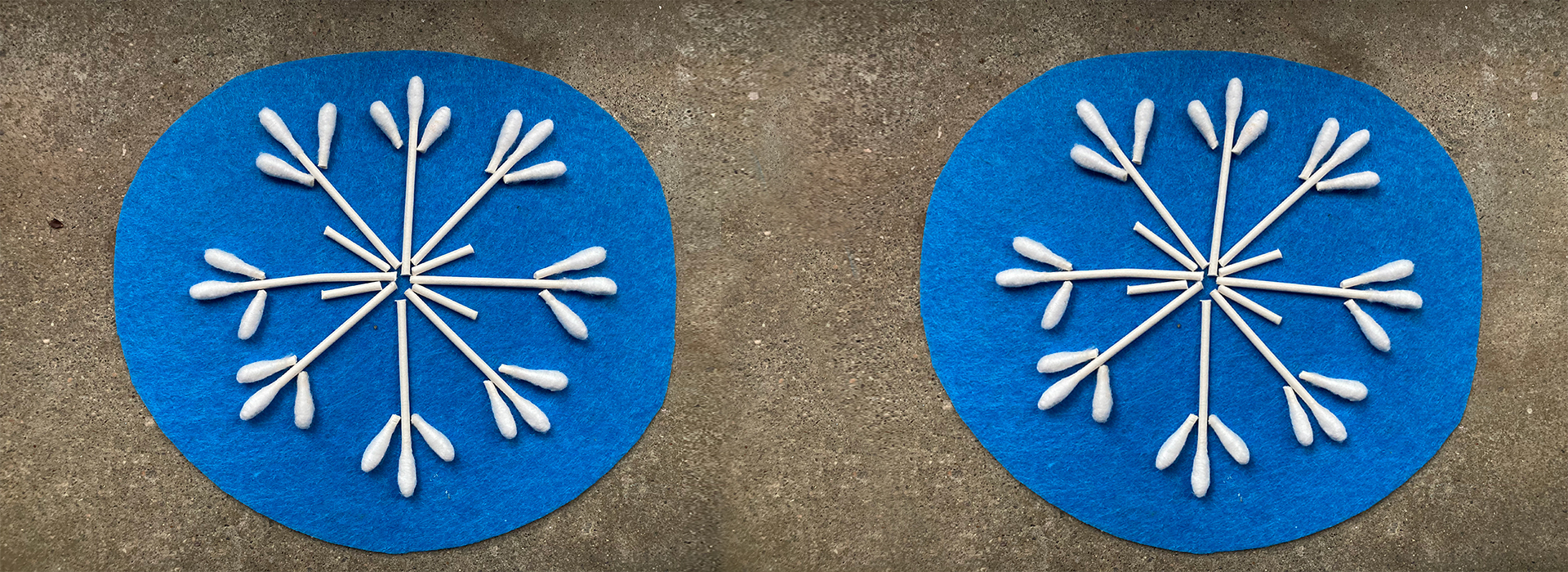 Two blue pieces of felt have snowflake shaped art made out of cotton swabs