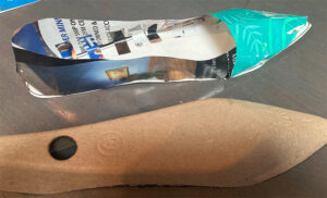 A women's shoe made out of paper scraps