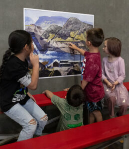 Children point at a painting