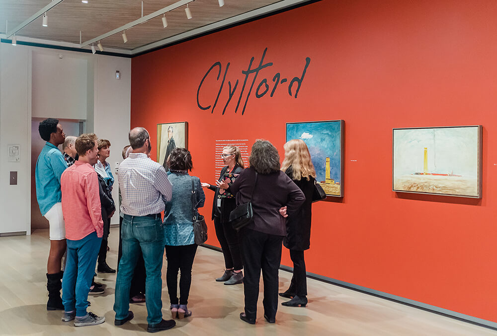 A group gets a tour in the Clyfford Still Museum