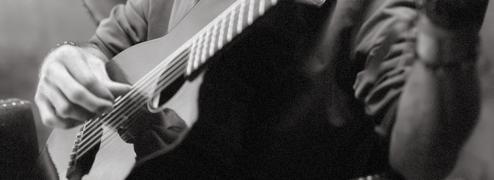 Black and white photo of a man playing the guitar