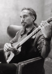 Black and white photo of a man playing the guitar