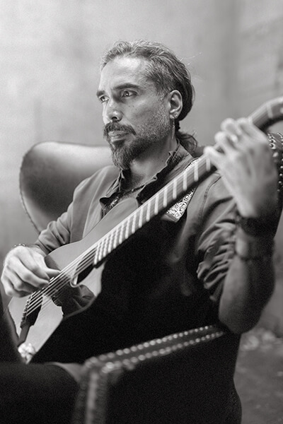 Black and white photo of a man playing the guitar