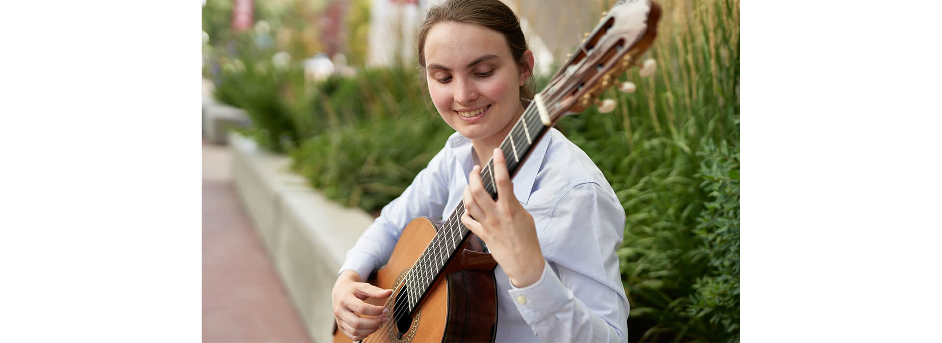 A woman plays classical guitar