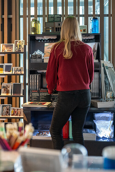 A woman looks at merchandise in the Clyfford Still Museum Shop