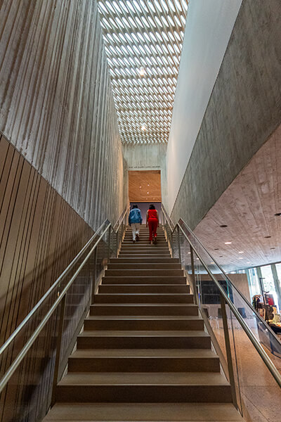 Two women walk up the main staircase at the Clyfford Still Museum