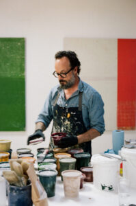 Kevin Appel in his art studio with paint