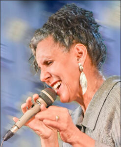 A woman sings into a microphone