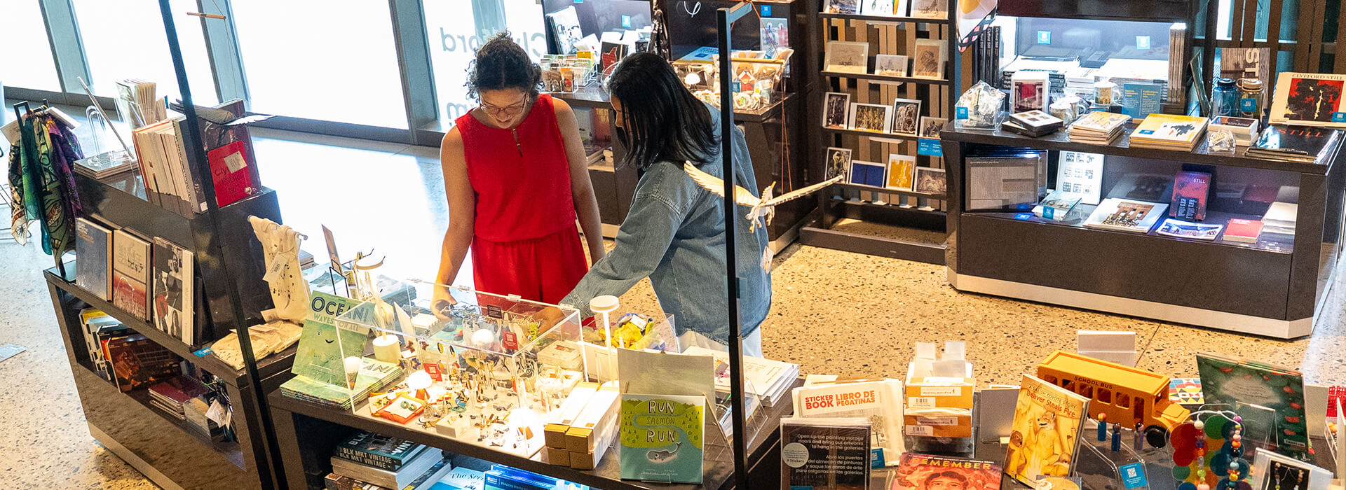 Two women look at merchandise in the Clyfford Still Museum Shop