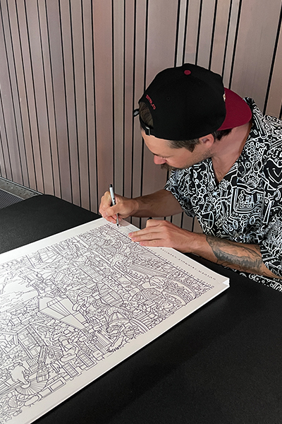 Artist Joe Palec signs posters