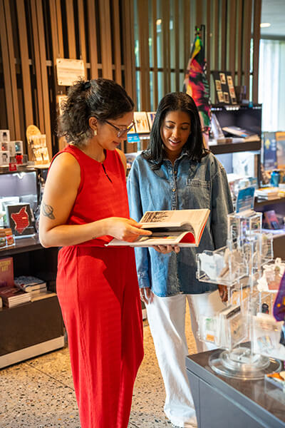 Two women look at merchandise in the Clyfford Still Museum Shop