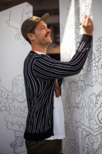 Artist Joe Palec illustrates on a large board
