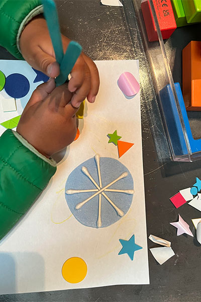 A child makes snowflake art