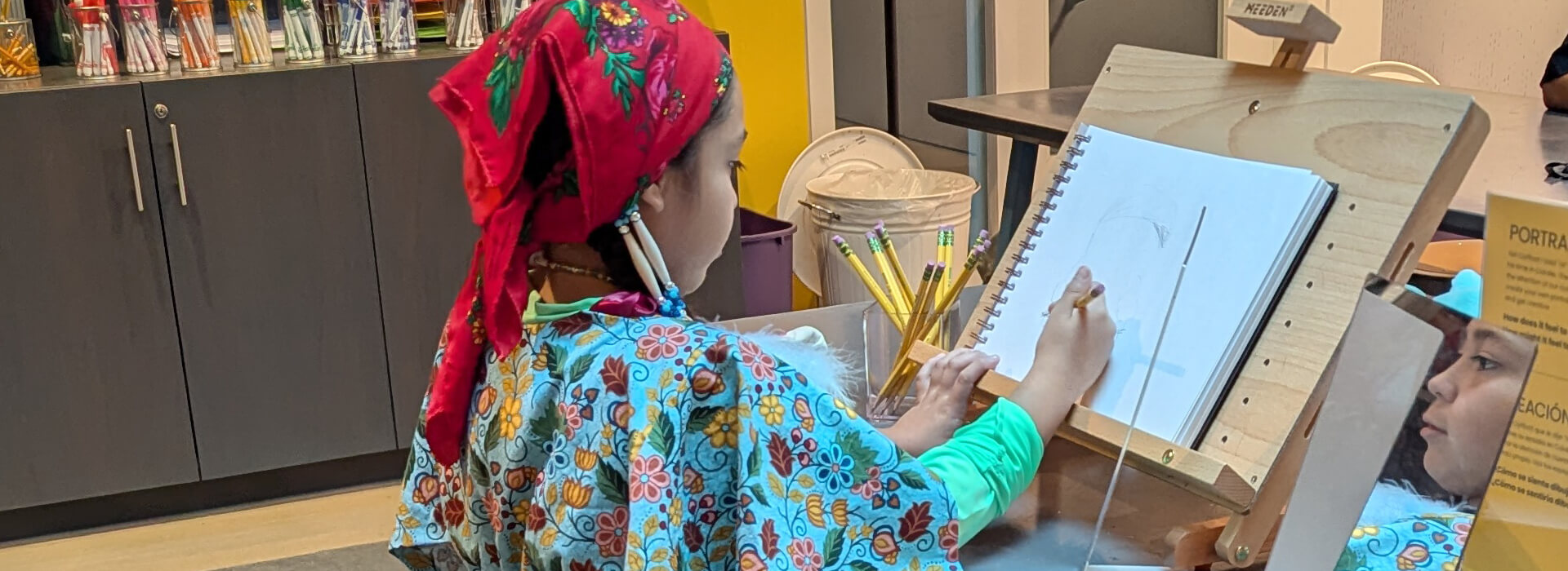 A child draws a self-portrait
