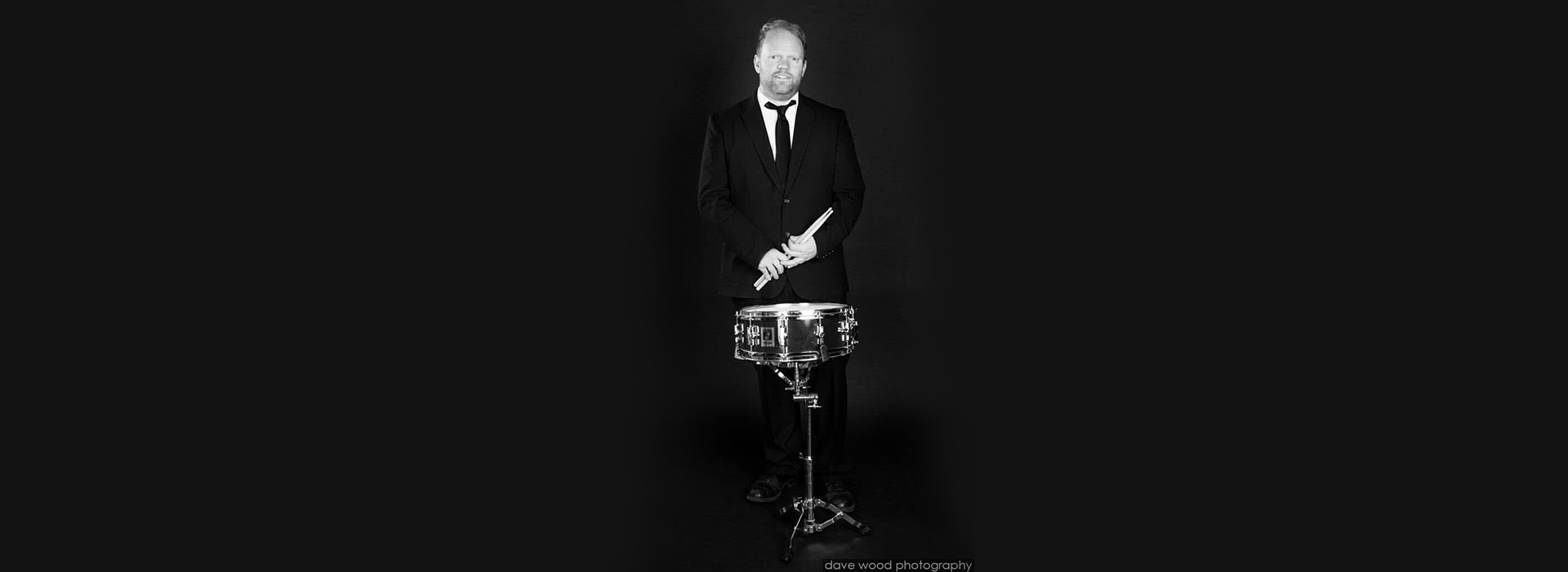 Stephen Brooks with a drum and drumsticks