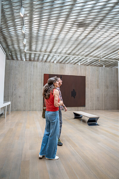 Two people look around a gallery
