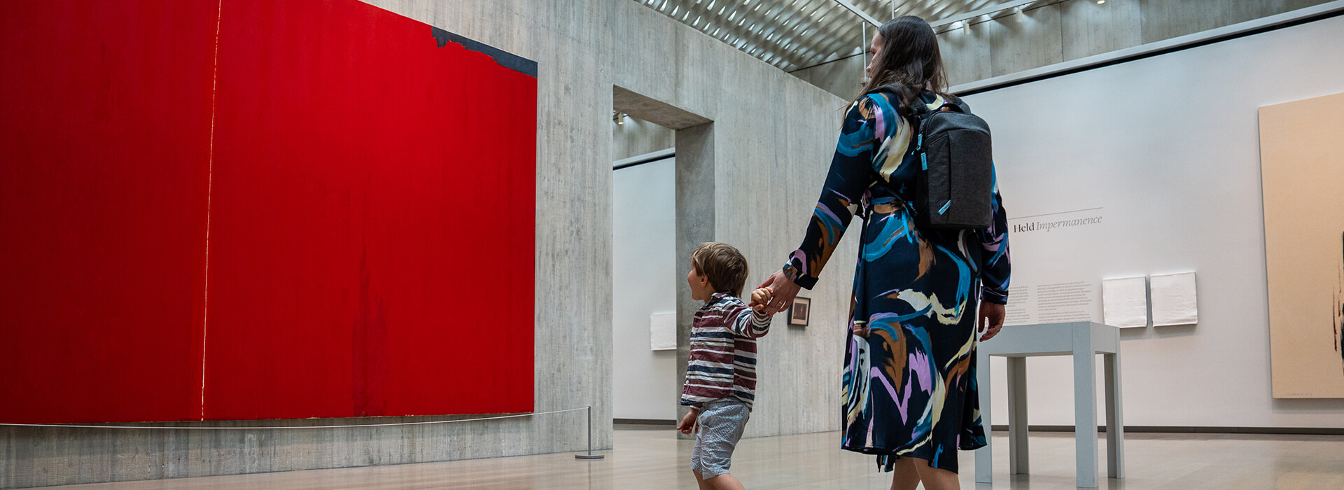 A young boy leads his mom by the arm in the galleries