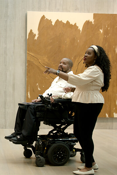 Marci Lundy and Stewart Tucker Lundy look at a painting in the galleries