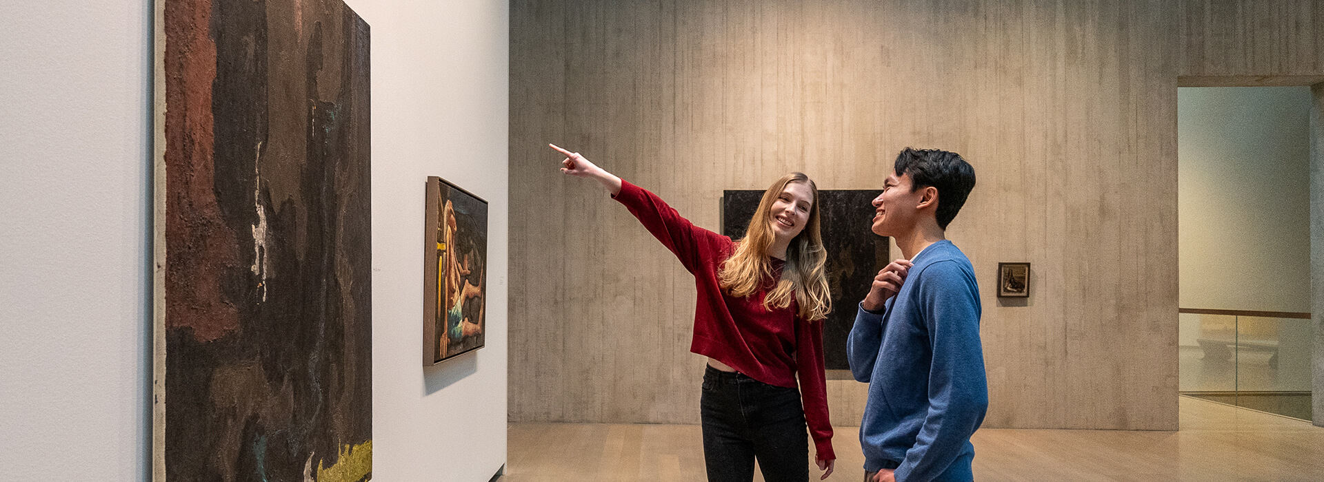 Two people look at an artwork