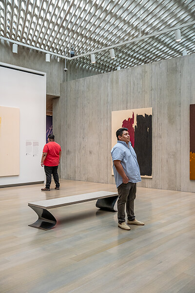 Two men look at art in the Clyfford Still Museum galleries
