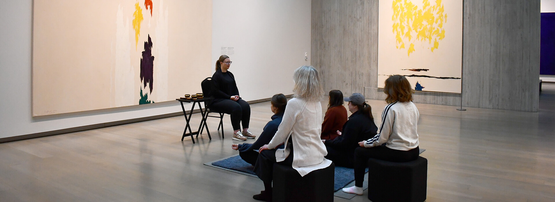 People meditating in a gallery