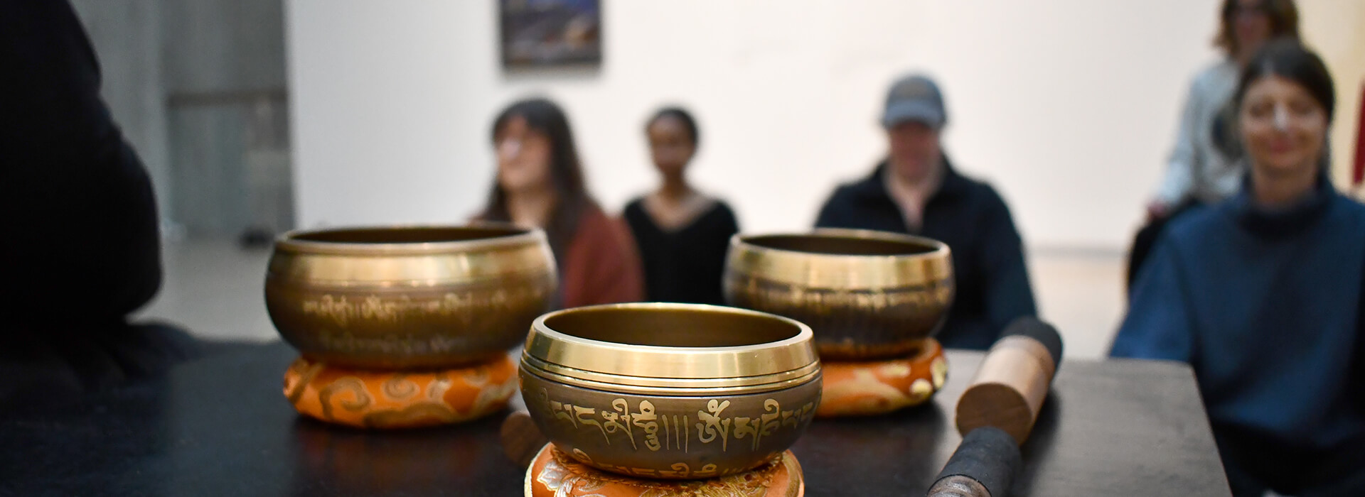 People meditating in a gallery