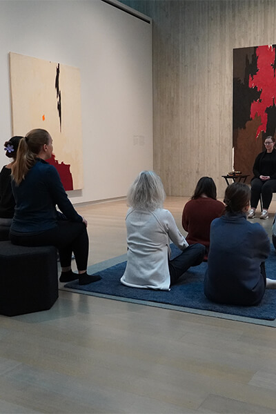 People meditating in a gallery