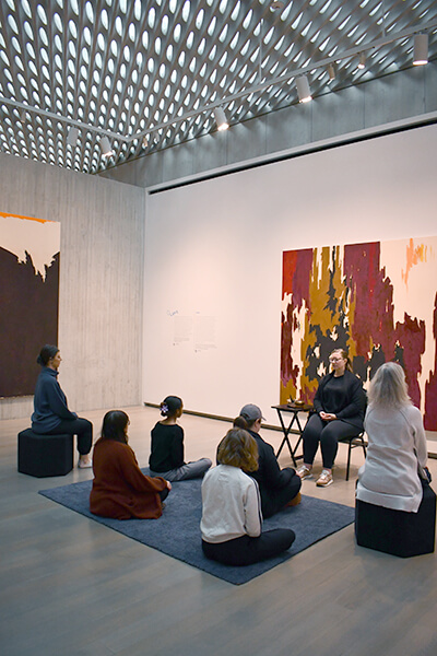 People meditating in a gallery