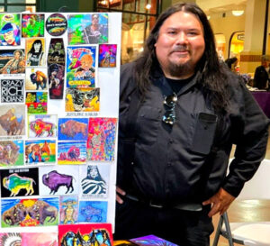 Artist Frank Andrews stands next to his sketches