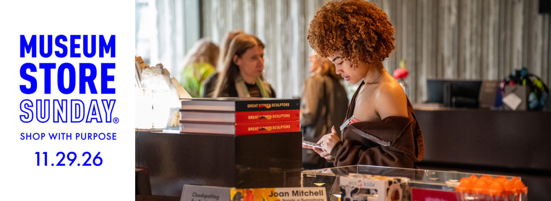 A young woman looks at items in the Clyfford Still Museum Shop and Museum Store Sunday logo