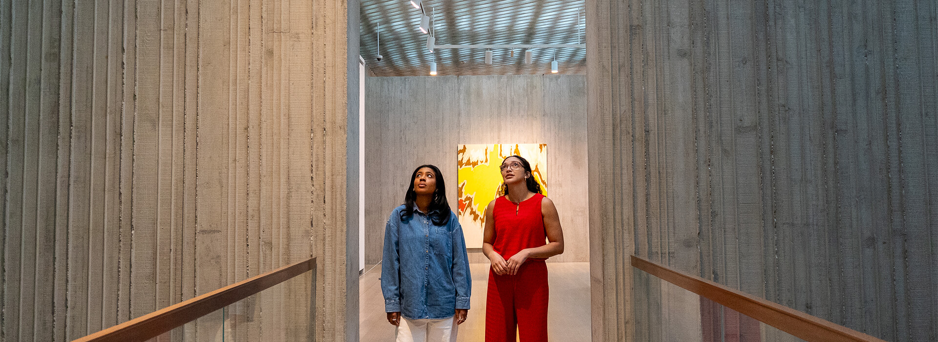 Two women look up at the ceiling at the Clyfford Still Museum